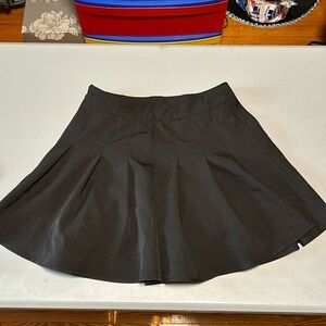 Black pleated miniskirt by SHEIN with back zip closure. Worn once.